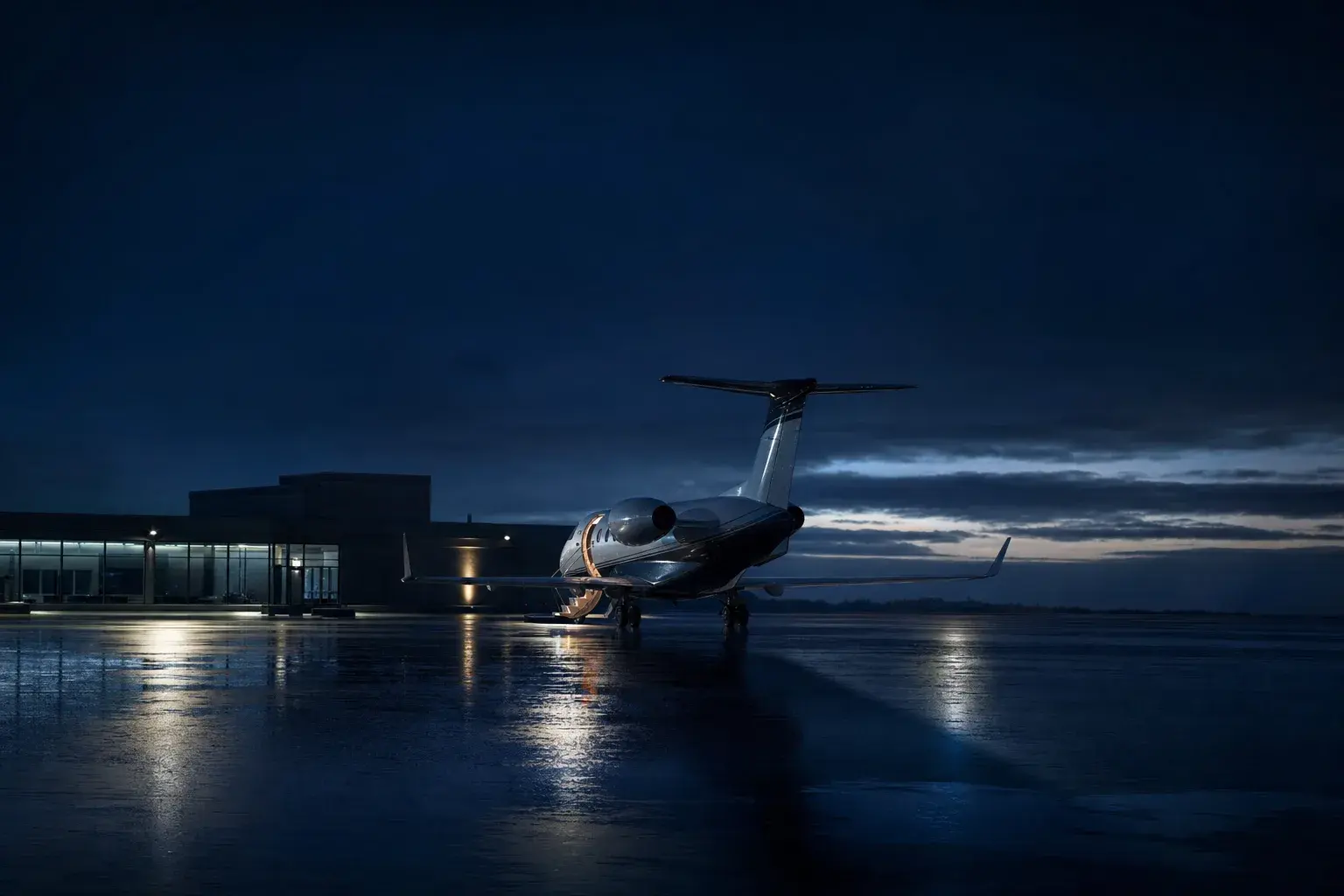 Midsize jet parked on an apron at a business aviation terminal before a one-way private jet flight